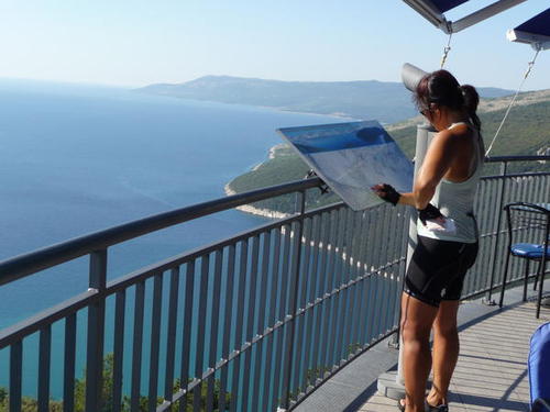 P1030924 Ann checking out the map at the overlook. We are headed to the ferry which we take over to Beli on the island of Cres.