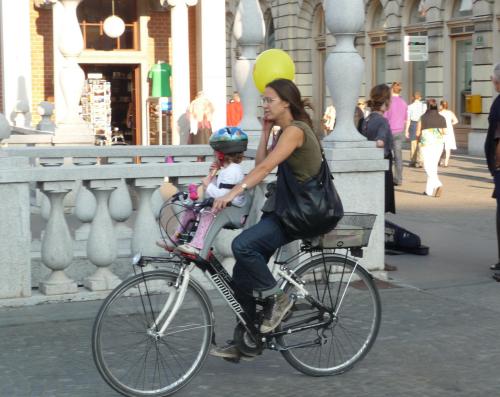  Kids as passengers are common.  So is the cell phone.  Helmets are generally considered kid stuff, but I guess there isn't much car traffic so perhaps not so bad.
